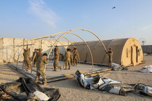 U.S. Army Soldiers assigned to Headquarters and Headquarters Troop, 6th Squadron, 17th Cavalry Regiment, Task Force Nighthawk use a forklift to move components of an Alaskan tent to the designated set-up area at Northern Landing Zone, Syria on...