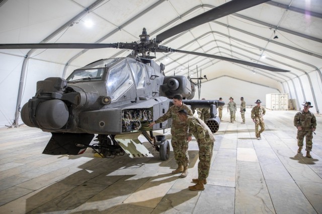 U.S. Army Col. Cameron G. Gallagher, commander of 4th Combat Aviation Brigade, Task Force Pegasus, shows Mr. Nihar Patel, chief technology officer for 4th Infantry Division, components of the AH-64D Apache Attack Helicopter in a Large Area...