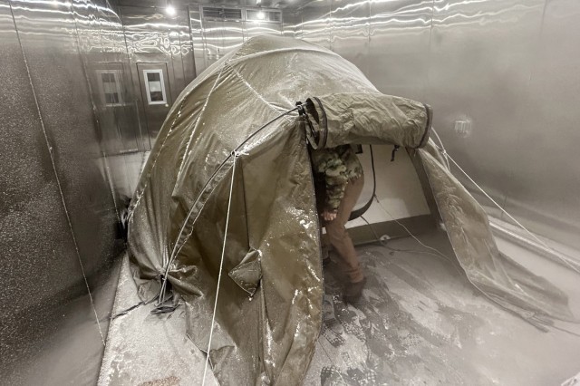 Ben Williams, a mechanical engineer at the Army Combat Capabilities Development Command Soldier Center in Natick, Mass., climbs into a tent in a chamber set to minus 40 degrees Fahrenheit at the nearby U.S. Army Research Institute of Environmental...
