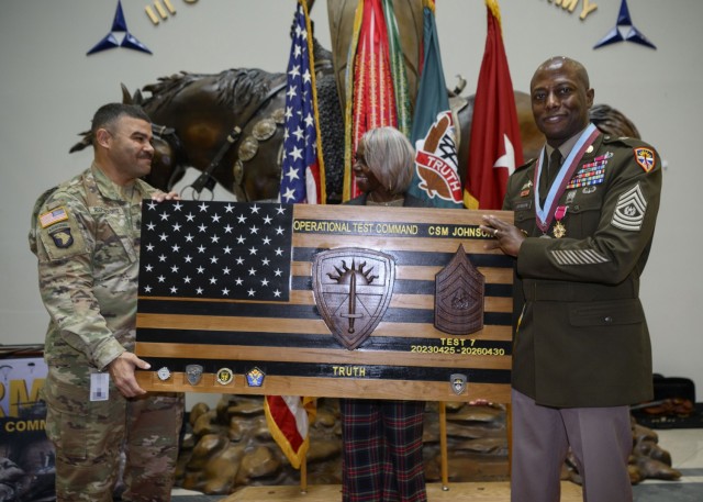 First Sgt. Pedro G. Rodriguezortiz (left), U.S. Army Operational Test Command’s Headquarters and Headquarters Company first sergeant, presents OTC Command Sgt. Maj. Joe E. Johnson with a farewell gift from the Soldiers and Army Civilian...