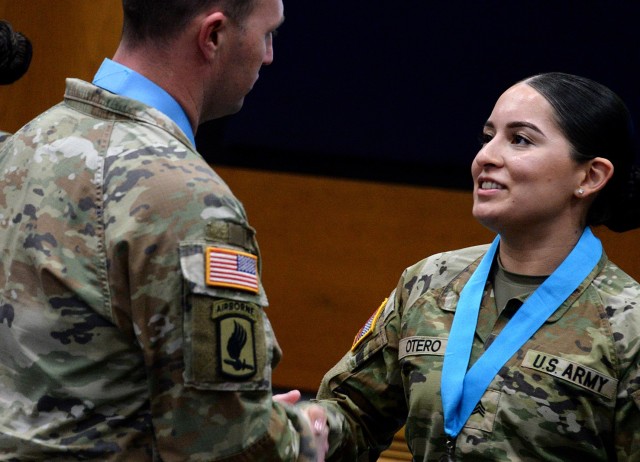 Sgt. Janelis Otero, Headquarters and Headquarters Company, U. S. Disciplinary Barracks Battalion (Corrections), is congratulated by guest speaker Sgt. Maj. Daniel Dodds, USDB Battalion operations sergeant major and senior enlisted advisor to...
