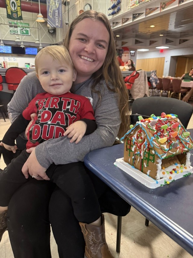 Gingerbread showdown contestants show off their gingerbread house as Fort McCoy community members participate in the 2025 Breakfast with Santa, Gingerbread House Showdown event Dec. 5, 2025, at Fort McCoy, Wis. Dozens of Fort McCoy community...