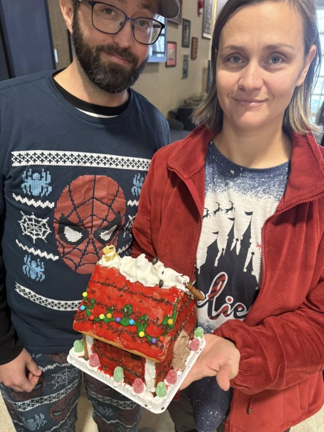 Gingerbread showdown contestants show off their gingerbread house as Fort McCoy community members participate in the 2025 Breakfast with Santa, Gingerbread House Showdown event Dec. 5, 2025, at Fort McCoy, Wis. Dozens of Fort McCoy community...