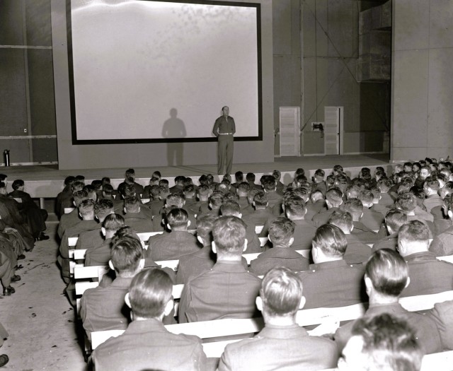 Soldiers training at Camp McCoy, Wis., receive a briefing in a theater building in late 1942. Tens of thousands of Soldiers trained at McCoy during World War II. (U.S. Army Historical Photo)