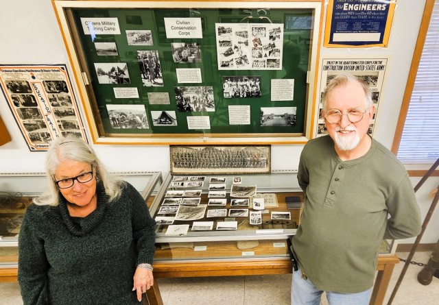 Judy and Scott Gill of Prairie du Chien, Wis., stand next two 26 World War II-era photos Dec. 2, 2025, in the Fort McCoy (Wis.) History Center that they donated to the center for historical documentation. They stated the photos originated from a...