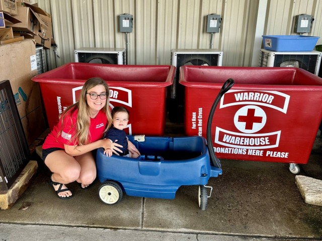 Christy and Mason Miller pose for a photo at the Fort Knox Red Cross Warrior Warehouse during a day of volunteering. (Photo provided by the Sgt. First Class Alexander Miller)