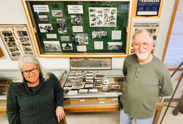 Judy and Scott Gill of Prairie du Chien, Wis., stand next two 26 World War II-era photos Dec. 2, 2025, in the Fort McCoy (Wis.) History Center that they donated to the center for historical documentation. They stated the photos originated from a...