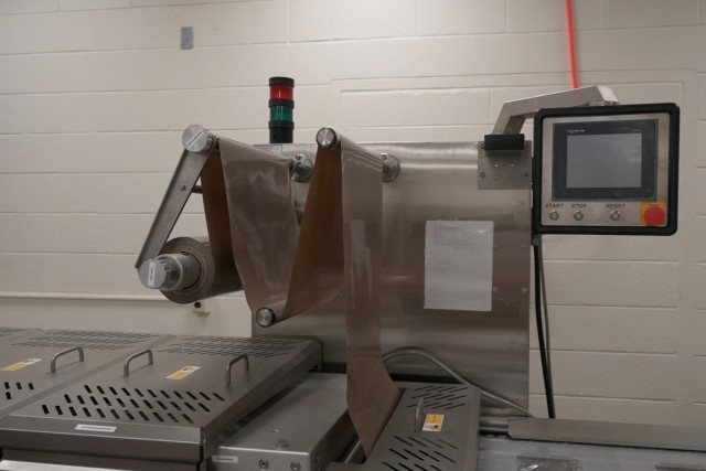 A thermoforming machine is on display at the Army Combat Capabilities Development Command Soldier Center's Combat Feeding Division in Natick, Mass., July 8, 2025. A thermoforming machine heats a plastic sheet until it’s pliable, then forms...