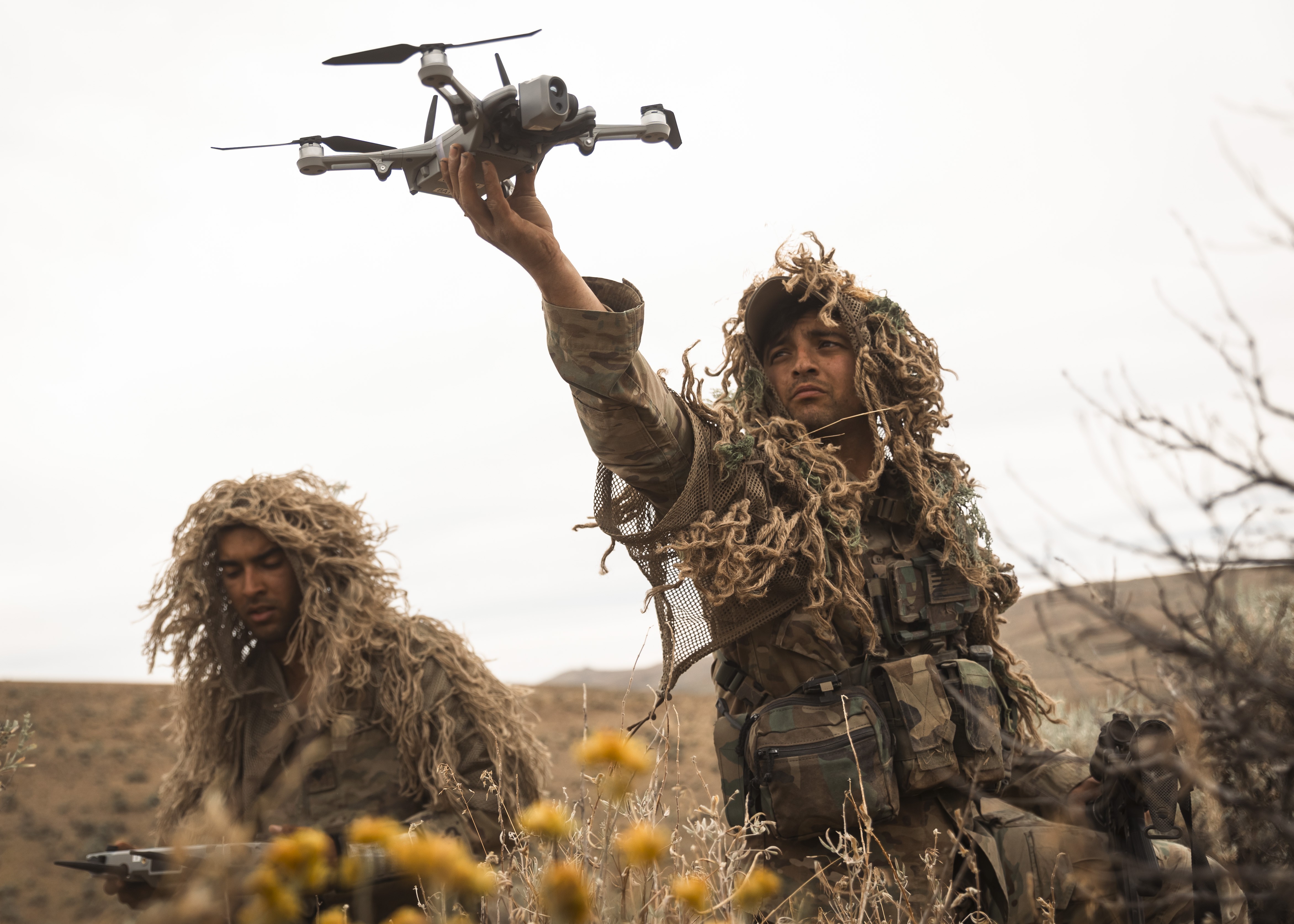 U.S. Army Spc. Benjamin Bell, left, and Sgt. Mackenzie Jones, snipers with the Long Range Surveillance Section, 81st Stryker Brigade Combat Team, Washington National Guard, launch a drone during combined training event Raven Focus at Yakima...