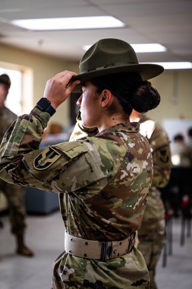 U.S. Army Staff Sgt. Joanna Romero, a Drill Sergeant Leader assigned to the U.S. Army Drill Sergeant Academy, tries on a campaign hat at Fort Jackson, S.C., Nov. 24, 2025. The campaign hat will become the official Drill Sergeant hat for females...