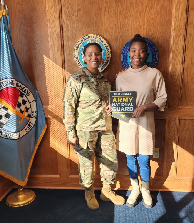 U.S. Army Sgt. 1st class Malika Moore, a Recruiting and Retention NCO with the Recruiting and Retention Battalion, New Jersey Army National Guard, left, and Spc. Sanaa Drinks, right pose for a photo following an oath of enlistment at Joint Base...