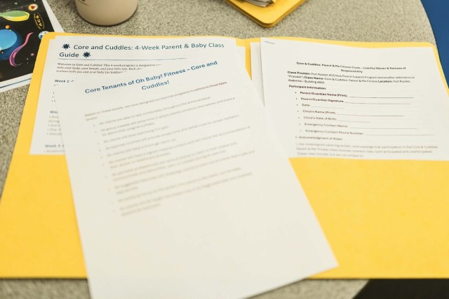 Resourceful packets are handed out to new parents that attend Core and Cuddles, a new strength focused playgroup offered through the new parent support program at the physical fitness center on Jan. 9.