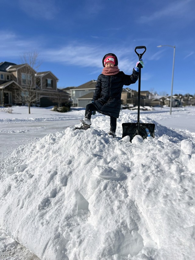 Eight-year-old Sophie Hong “conquers” the snow after helping shovel her family’s driveway, with the hope of returning to school the next day, Jan. 6, 2025, on Fort Leavenworth. School was cancelled Jan. 6-8, 2025, due to the weather....
