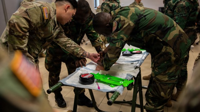 U.S. Army Sgt. Caleb Flynn, medic assigned to Army Health Clinic - Vicenza, and members of Armed Forces of Liberia and Ghana Armed Forces assess a simulated casualty during a partnered medical training exercise led by U.S. Army Southern European...