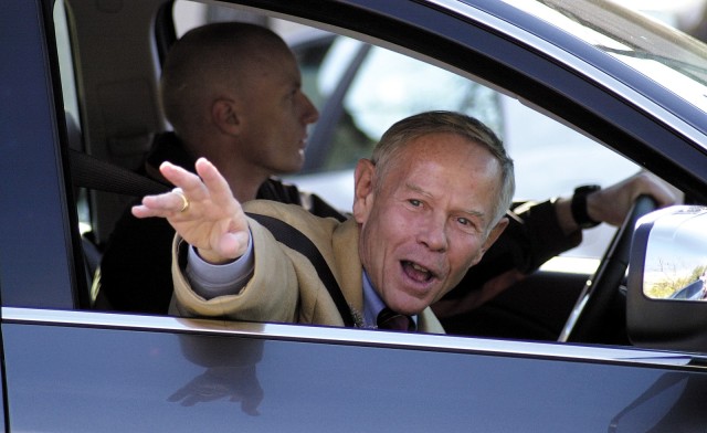 Veterans Day Parade Grand Marshal Jack Walker, deputy to the garrison commander, waves to the Waugh family as the annual parade makes its way through downtown Leavenworth Nov. 11, 2005. Photo by Prudence Siebert/Fort Leavenworth Lamp
