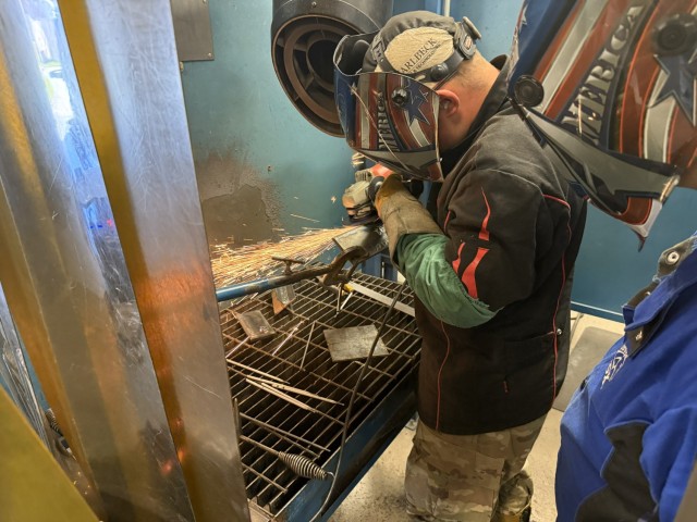 SSG Thomas Dunn instructs PFC Rylan Reader how to grind bevels at Fort Lee, Virginia, Oct. 8, 2025.