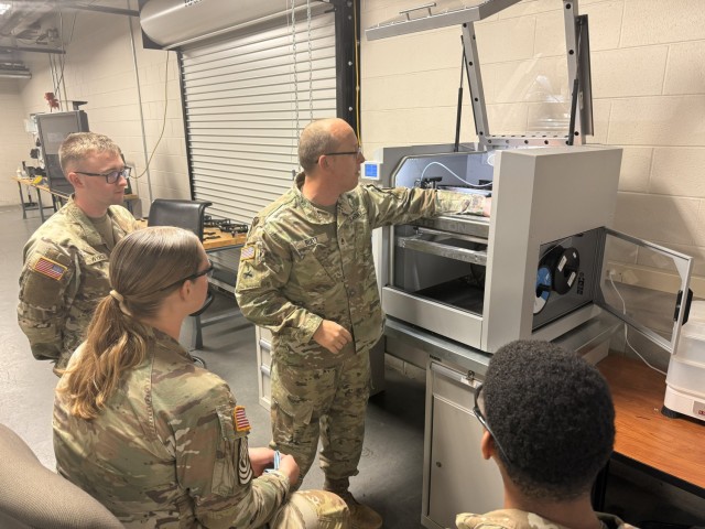 SSG Keith Ruetz instructs PV2 Nathiel Wyrick, PVT Tyrae Williams, and PV2
Sydney Hayward how to calibrate the 3D printer at Fort Lee, Virginia, on Oct. 8, 2025.