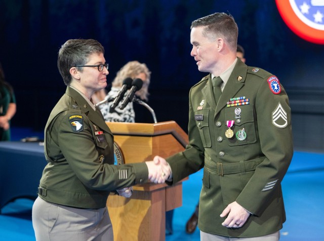 Brig. Gen. Sara Dudley, commanding general of the U.S. Army Recruiting Division, shakes hands with Staff Sgt. Chance Shutter.