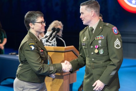 Brig. Gen. Sara Dudley, commanding general of the U.S. Army Recruiting Division, shakes hands with Staff Sgt. Chance Shutter.