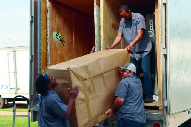 Movers deliver household goods for a military family at Fort Campbell, Ky., May 9, 2022.