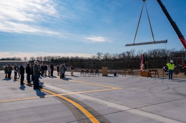 Fort Leonard Wood, St. Robert and Waynesville community members watch the final structural beam of the Waynesville-St. Robert Regional Airport’s expansion project be hoisted into place, Jan. 22 during a topping-out ceremony, commemorating a...