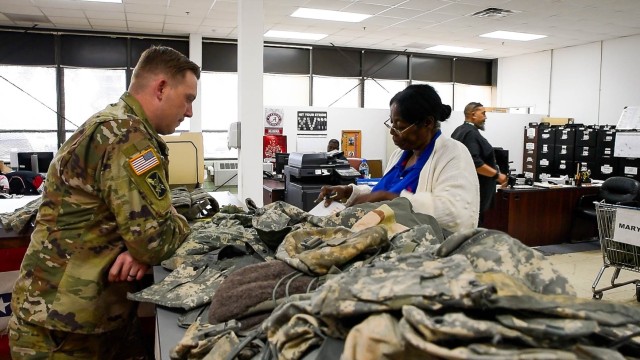 A Soldier from the 513th Military Intelligence Brigade works in March 2025 with a staff member at the Central Issue Facility that's part of the Logistics Readiness Center at Fort Gordon, Georgia.