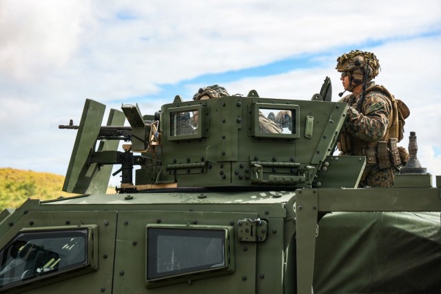 U.S. Marines with Headquarters and Service Company, Battalion Landing Team 3/6, 22nd Marine Expeditionary Unit (Special Operations Capable), fire a mounted M240B machine gun from a Joint Light Tactical Vehicle (JLTV) Reducible Height Gunner...