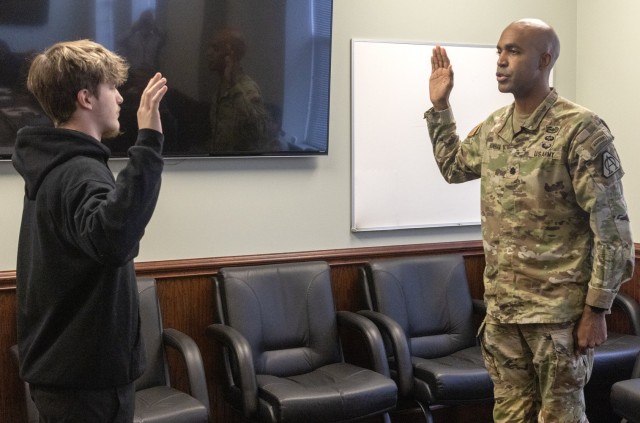 PICATINNY ARSENAL, N.J. - Lt. Col. Craig A. Bonham II, U.S. Army Garrison Picatinny Arsenal Garrison Commander administers the oath of enlistment to Keoni Dickinson. ...