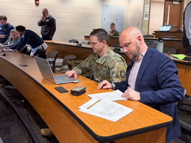 Josh Gregerson (right), director of talent acquisitions, and Sgt. 1st Class David Epp, Metro South Recruiting Station, review Accessions Information Environment (AIE) system reporting during a Screening Capability Development Event in...