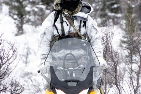 Green Beret operates snowmobile through Alaskan wilderness