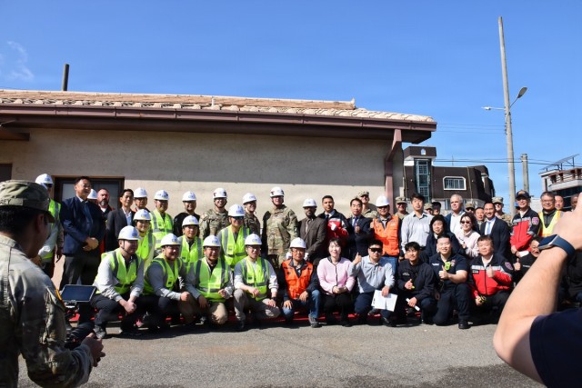 Sledgehammer swings mark start of Camp Walker emergency services project