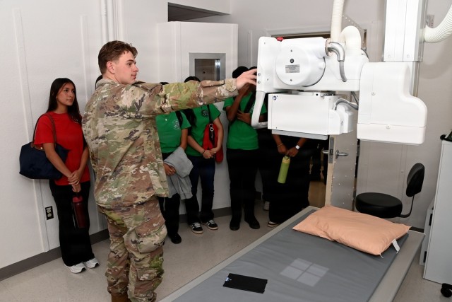 Spc. John Johnson of the U.S. Army Yuma Proving Ground Health Clinic shows the radiology department to a group of about 30 young people made up of both Army recruits under contract and members of San Luis High School’s Emergency Medical Services...