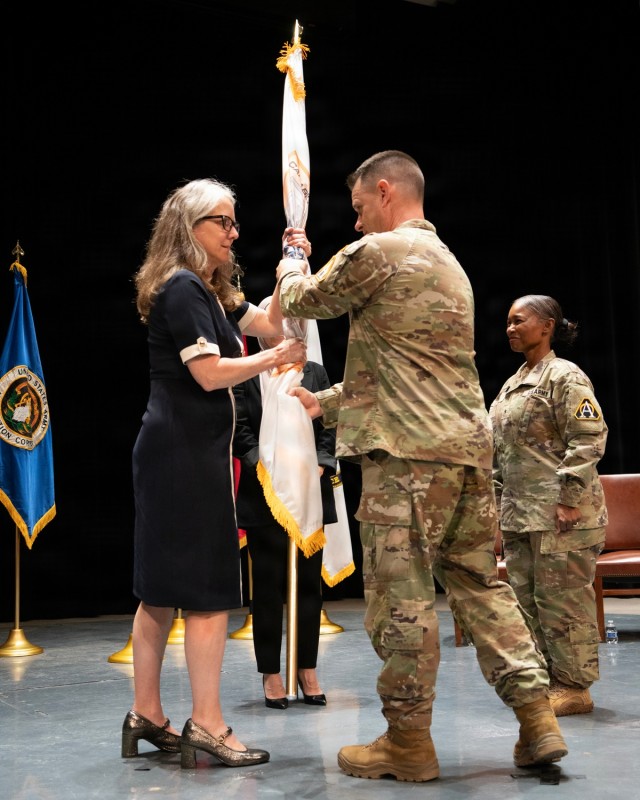 Michelle Link accepts the CPE Combat Sustainment Colors