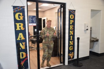 Brig. Gen. Beth Behn exits the barbershop after receiving the first haircut