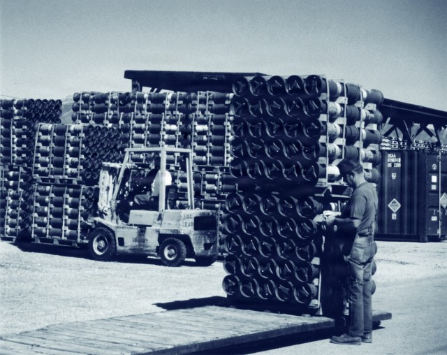 Tooele Ordnance Depot Personnel Inspect Stacked Artillery Rounds